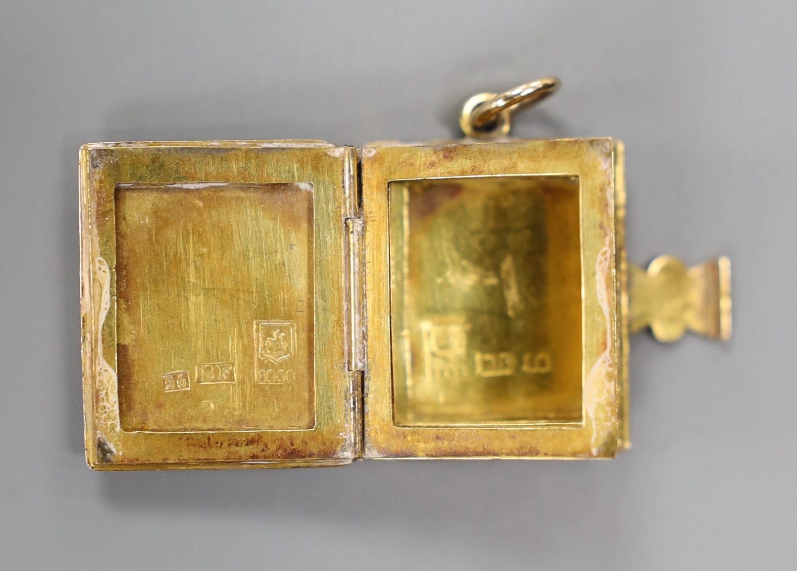 A 19th century Russian 56 zolotnik yellow metal photograph? souvenir case, modelled as a book, opening to reveal five vacant frames, master BF, Tiflus? 1862, 22mm, 10.4 grams.